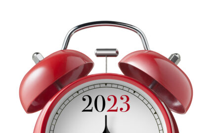 New Year 2023. Close up view of a red alarm clock.